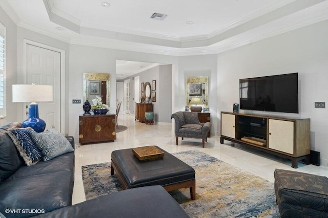 living room with ornamental molding, a raised ceiling, and a healthy amount of sunlight