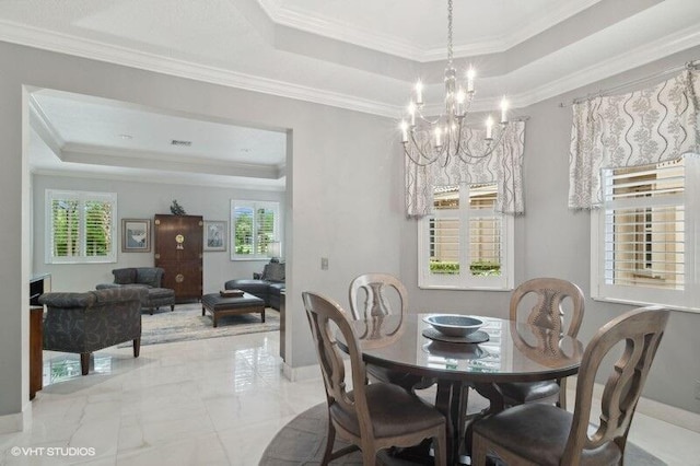 10103 Wild Quail Dr, Port Saint Lucie, FL 34986 - dining area with an inviting chandelier, ornamental molding, a raised ceiling, and marble finish floor