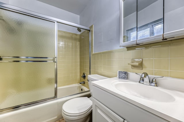 full bathroom with enclosed tub / shower combo, toilet, decorative backsplash, vanity, and tile walls