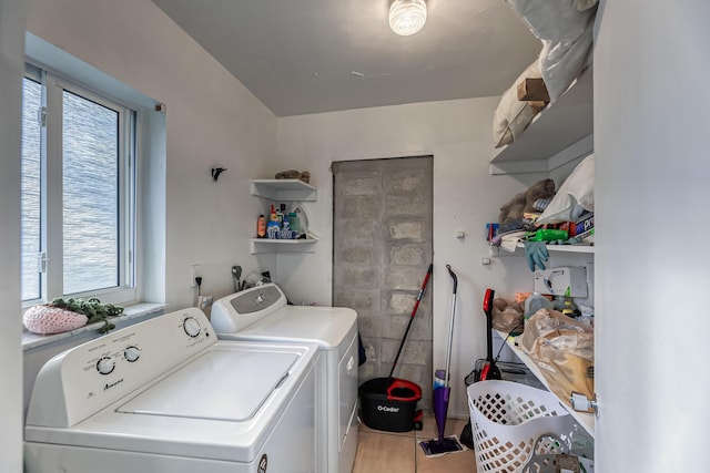 washroom featuring washing machine and dryer and light tile patterned flooring