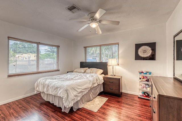 bedroom with ceiling fan and dark wood-type flooring