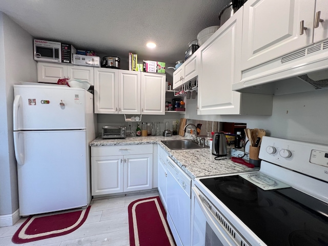 kitchen featuring white cabinetry, white appliances, a textured ceiling, light hardwood / wood-style flooring, and sink