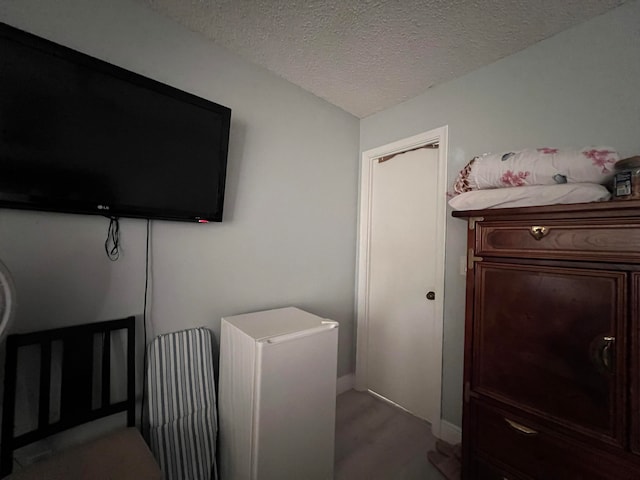 clothes washing area featuring a textured ceiling