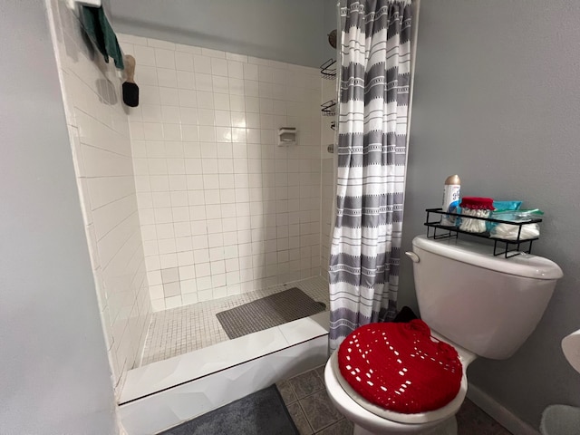 bathroom with a shower with curtain and toilet