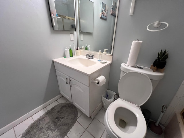 bathroom with vanity, tile patterned flooring, and toilet