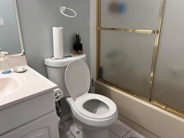 full bathroom with tile patterned flooring, bath / shower combo with glass door, vanity, and toilet