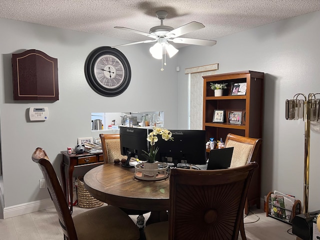 dining room featuring a textured ceiling and ceiling fan