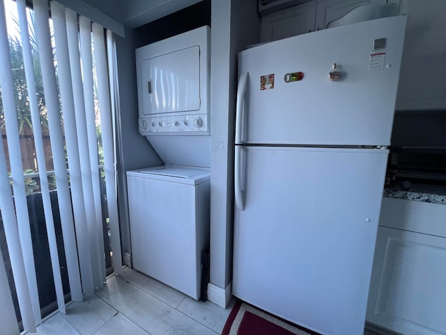 clothes washing area with stacked washer / dryer