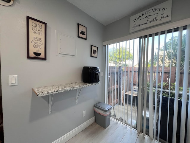 entryway featuring light wood-type flooring and a healthy amount of sunlight