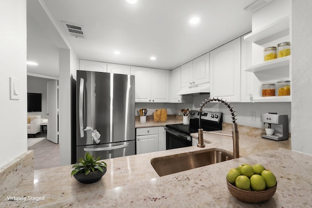 kitchen featuring light stone counters, appliances with stainless steel finishes, sink, and white cabinets