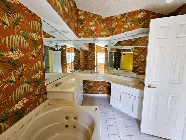 bathroom with vanity, a bathing tub, plenty of natural light, and ceiling fan