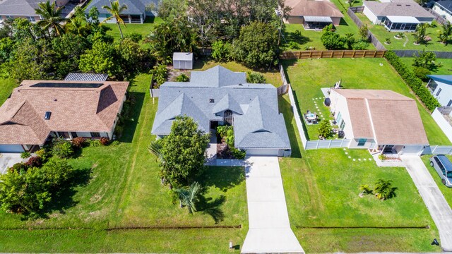 back of property featuring a sunroom and a lawn