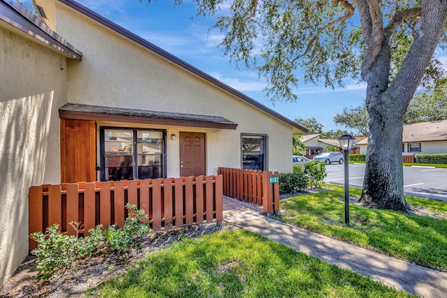 doorway to property featuring a yard