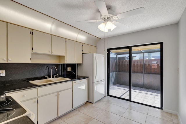 kitchen with sink, decorative backsplash, white appliances, light tile patterned floors, and ceiling fan