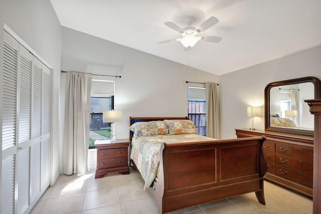 bedroom featuring ceiling fan, a closet, vaulted ceiling, and multiple windows