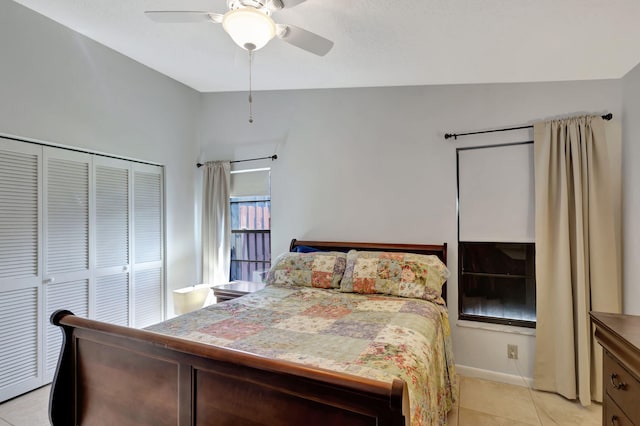 bedroom with a closet, vaulted ceiling, ceiling fan, and light tile patterned floors