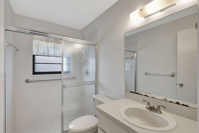 bathroom with vanity, toilet, and an enclosed shower