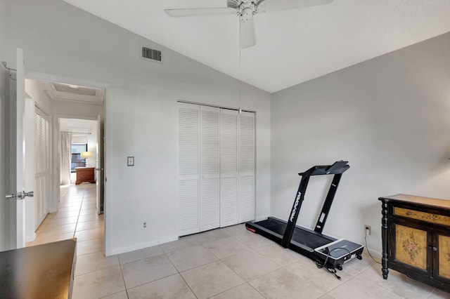 exercise area featuring lofted ceiling, ceiling fan, and light tile patterned floors