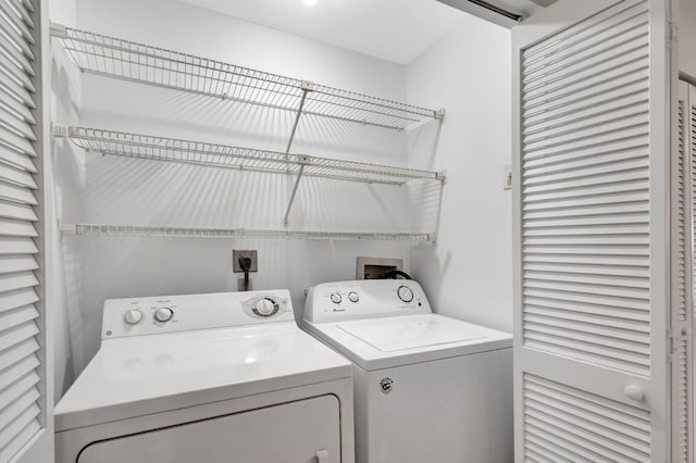 clothes washing area featuring washer and dryer