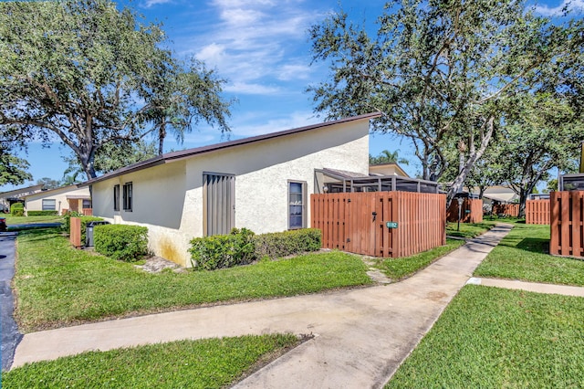 view of side of property with a lawn