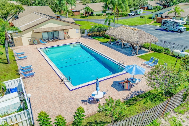 view of swimming pool featuring a lawn and a patio