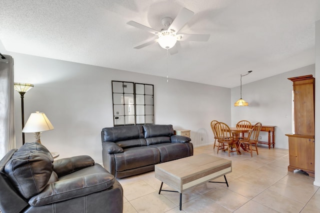 tiled living room with ceiling fan and a textured ceiling