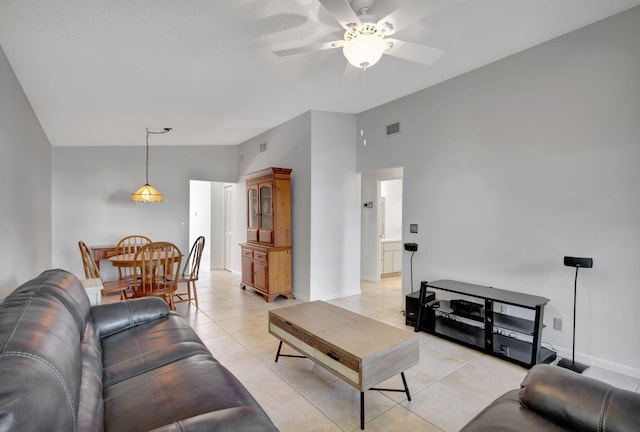 living room featuring ceiling fan, light tile patterned floors, and high vaulted ceiling