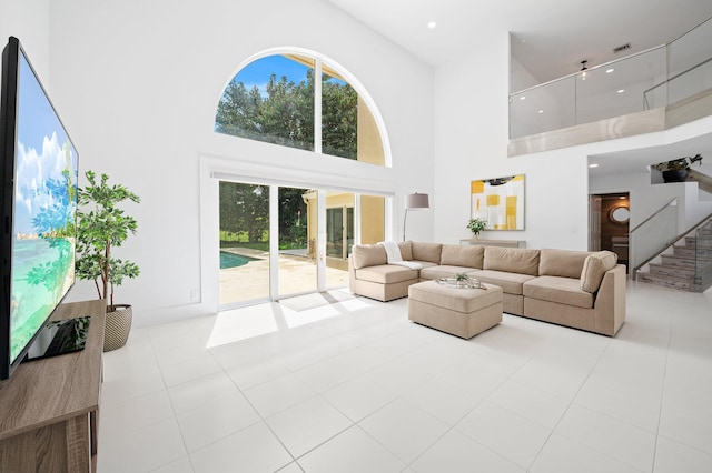 tiled living room featuring a towering ceiling