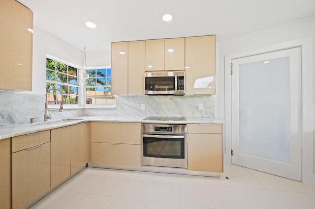 kitchen featuring backsplash, appliances with stainless steel finishes, sink, and light brown cabinets