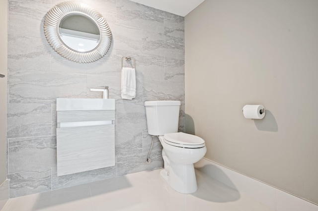 bathroom with vanity, tile walls, and toilet