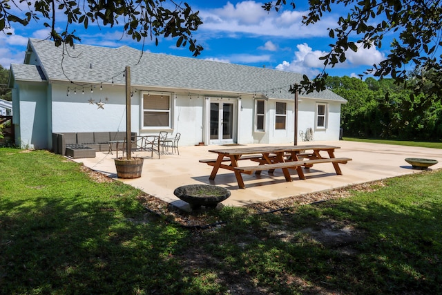 back of property featuring a yard and a patio