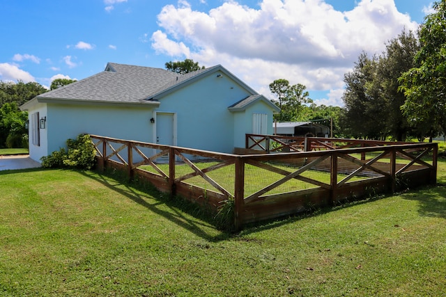 view of side of home featuring a lawn