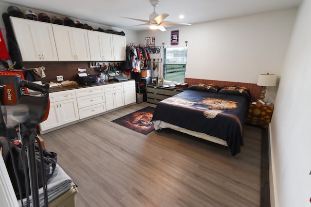 bedroom featuring light wood-type flooring and ceiling fan