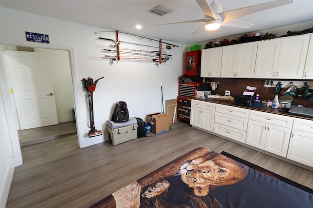 kitchen featuring white cabinetry, ceiling fan, dark hardwood / wood-style floors, and tasteful backsplash