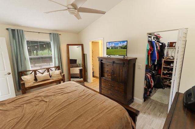 bedroom featuring a closet, light wood-type flooring, lofted ceiling, ceiling fan, and ensuite bathroom