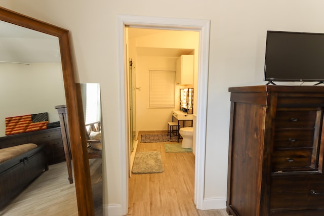 hallway with light hardwood / wood-style flooring