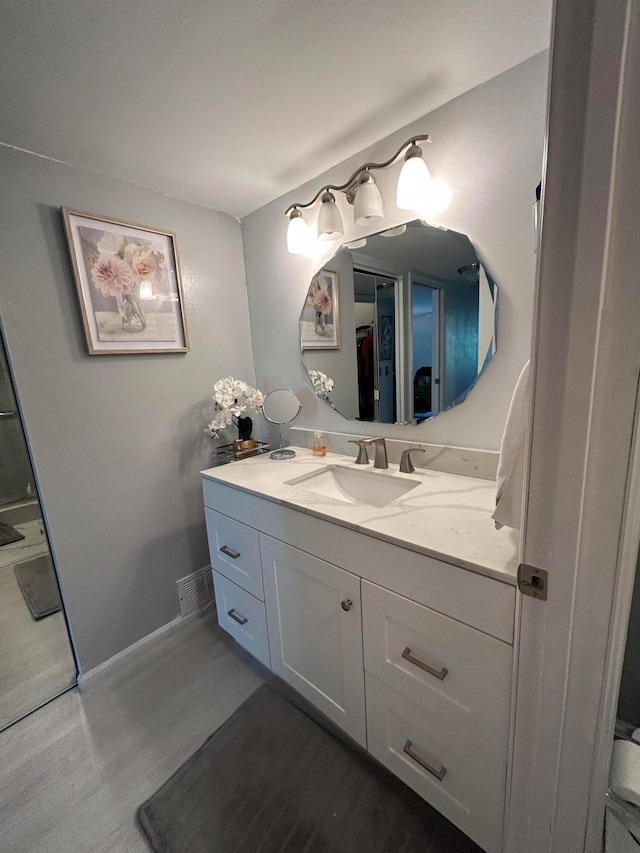 bathroom featuring vanity and hardwood / wood-style floors