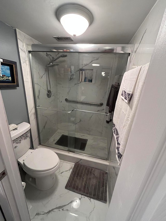 bathroom featuring an enclosed shower and toilet