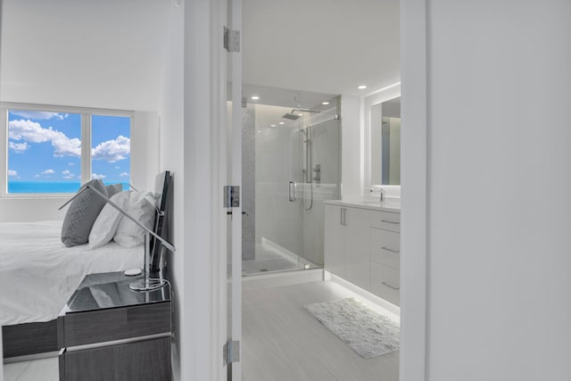 bathroom featuring vanity, hardwood / wood-style floors, and a shower with door