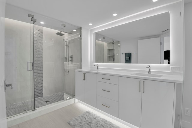 bathroom featuring vanity and an enclosed shower