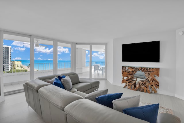 living room with floor to ceiling windows and a healthy amount of sunlight