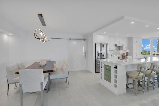 dining space featuring sink and light hardwood / wood-style flooring