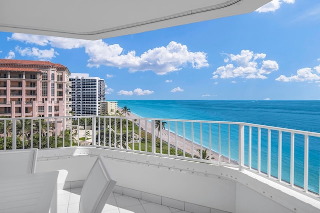 balcony featuring a beach view and a water view