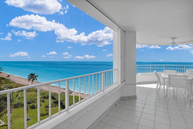 balcony featuring a water view and a beach view