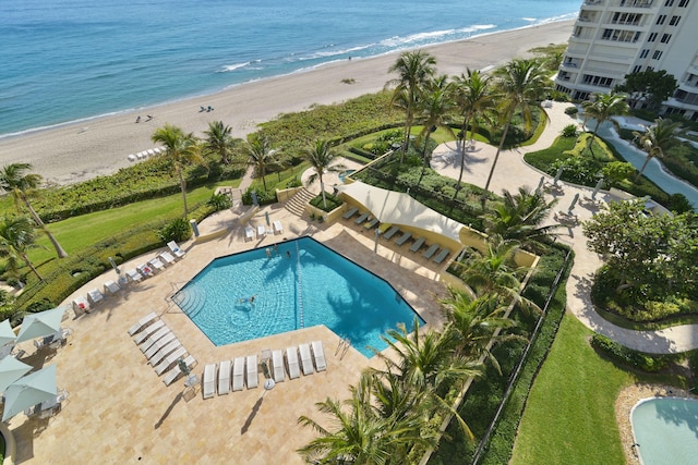 view of pool with a view of the beach, a water view, and a patio area