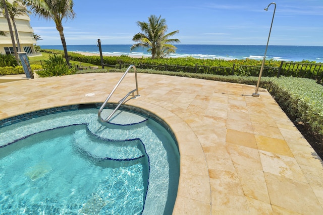 view of pool featuring a water view and a patio area