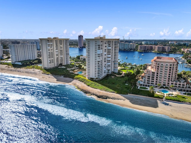 drone / aerial view with a water view and a beach view