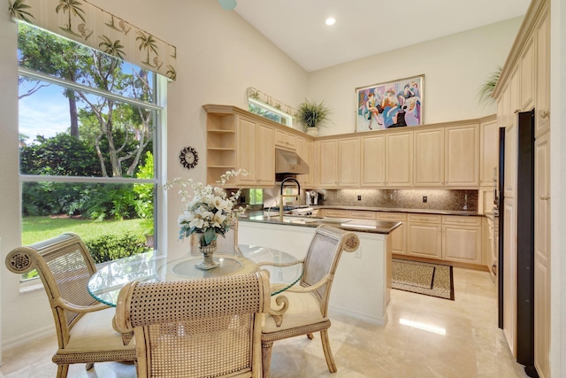 dining area featuring a high ceiling