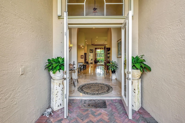 doorway to property featuring stucco siding