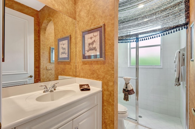 bathroom featuring vanity, a shower stall, and toilet